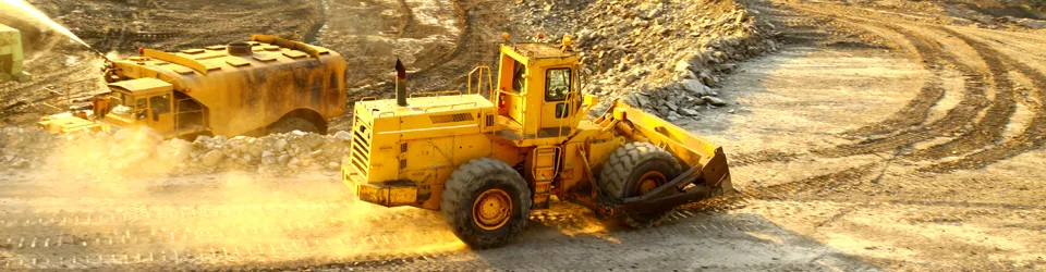 Mining equipment working on an open-pit haul road